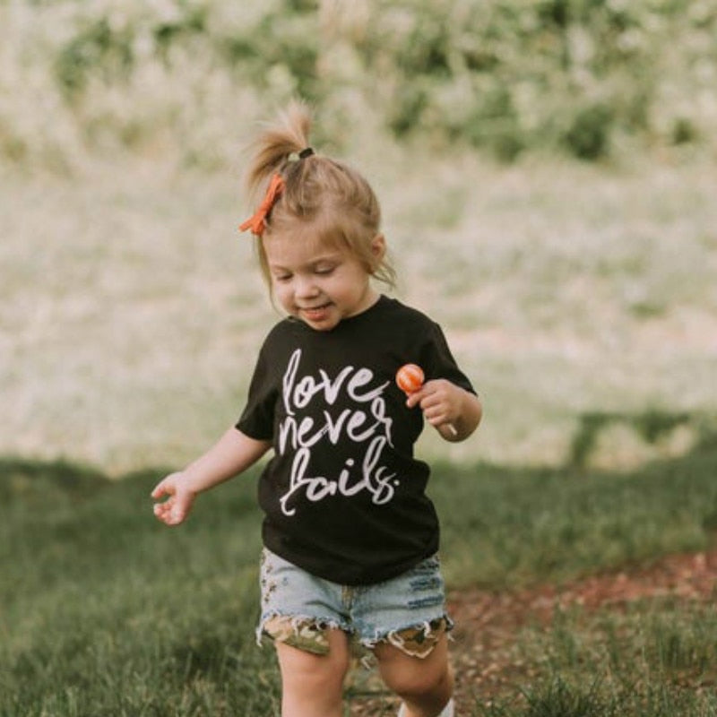 Love Never Fails Girls Christian Heart Shirt